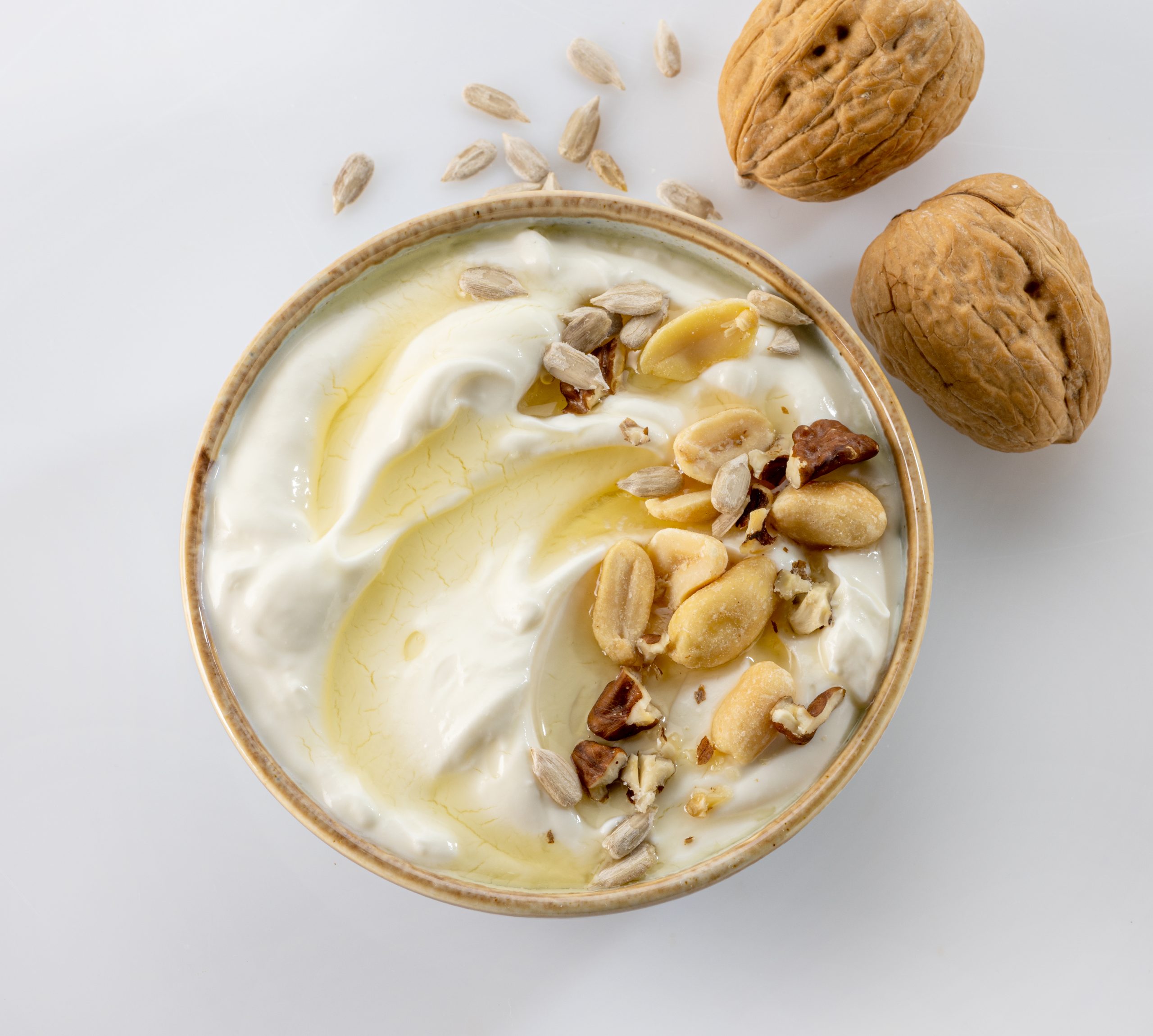 A bowl of creamy keto diet yogurt topped with nuts and seeds, a perfect low-carb snack or breakfast.
