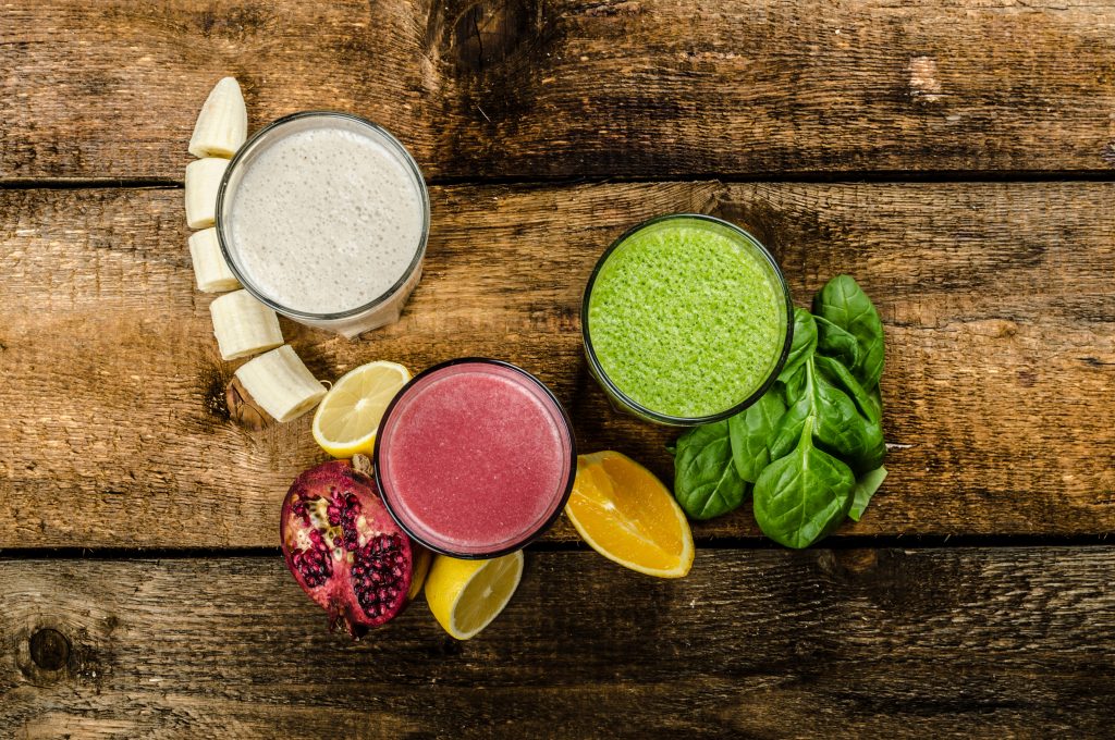 Healthy smoothie - banana-vanilla, pomegranate and orange, spinach and herbs