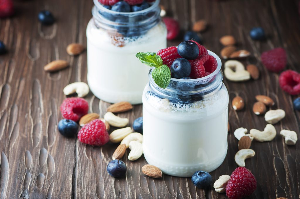 Healthy yogurt with berry and nuts, selective focus