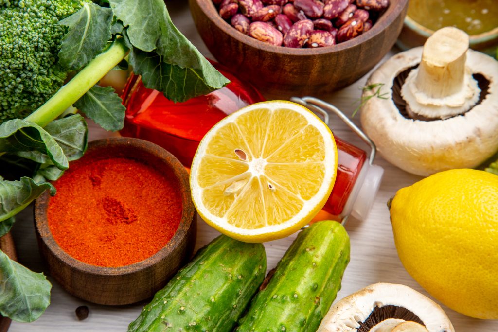 Horizontal view of collection of fresh foods and spices vegetables on white background